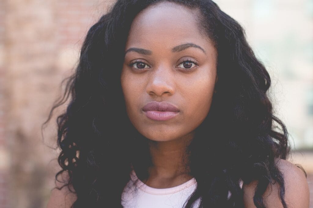 Hopeful woman looking directly into the camera, representing emotional healing, self-trust, and renewal after depression.